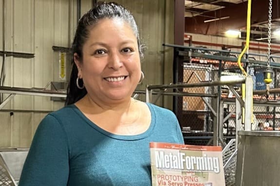Ilda Mandujano holding a Metal Forming Magazine where she was awarded "Woman of Excellence in Manufacturing"
